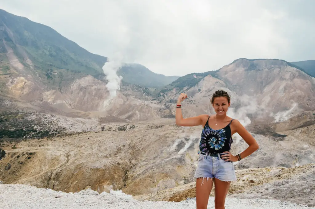 flexing muscle on top of active volcano