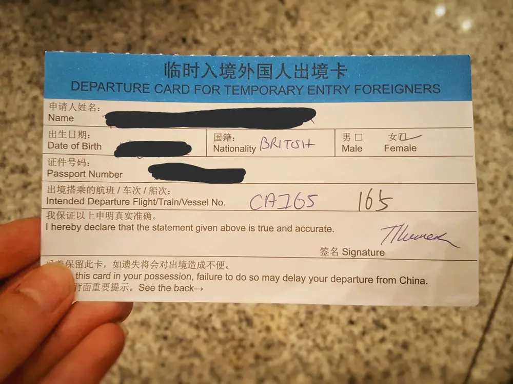 hand holding china visa temporary entry card