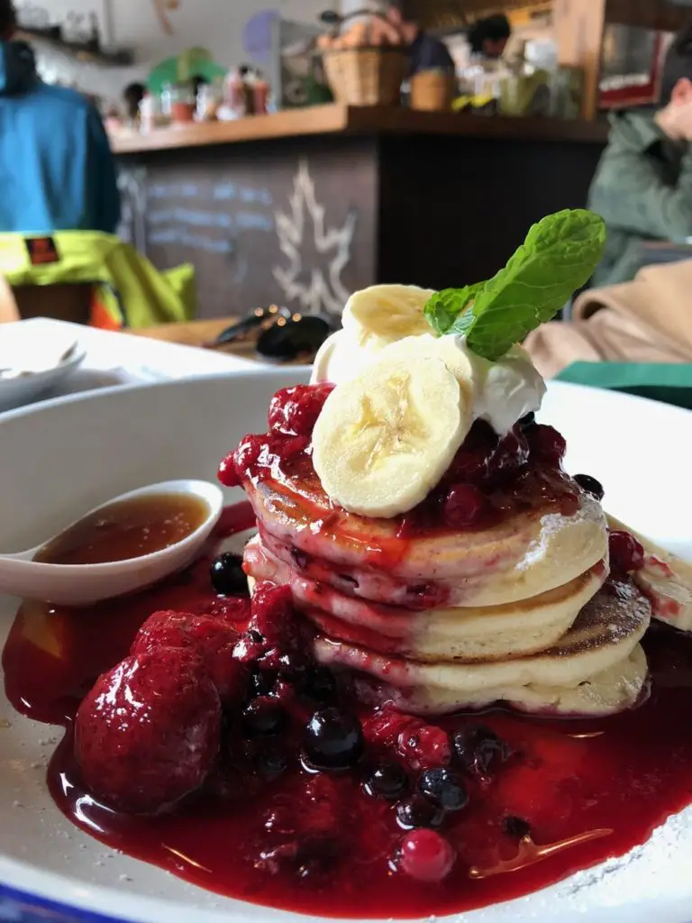 stack of pancakes with fruit coulis