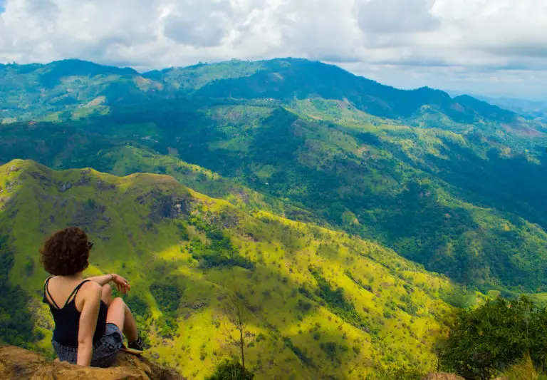 A girl sat on Ella's rock in Sri Lanka.