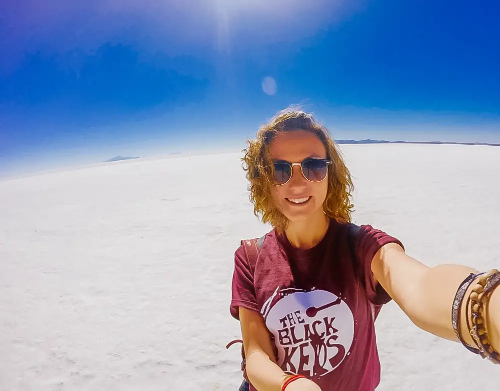 girl taking selfie on the salt flats of bolivia