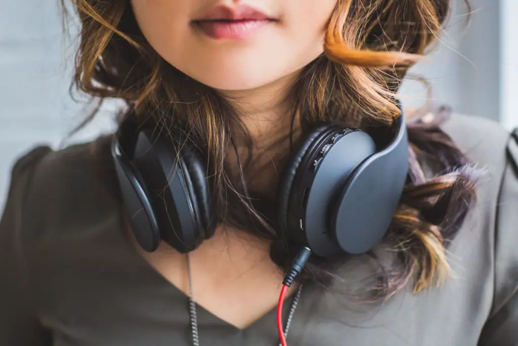 girl with headphones around neck