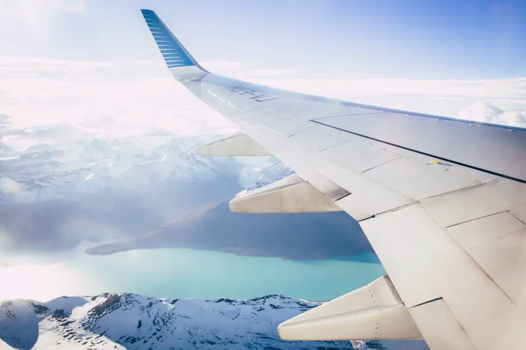 aeroplane wing with mountains and lake