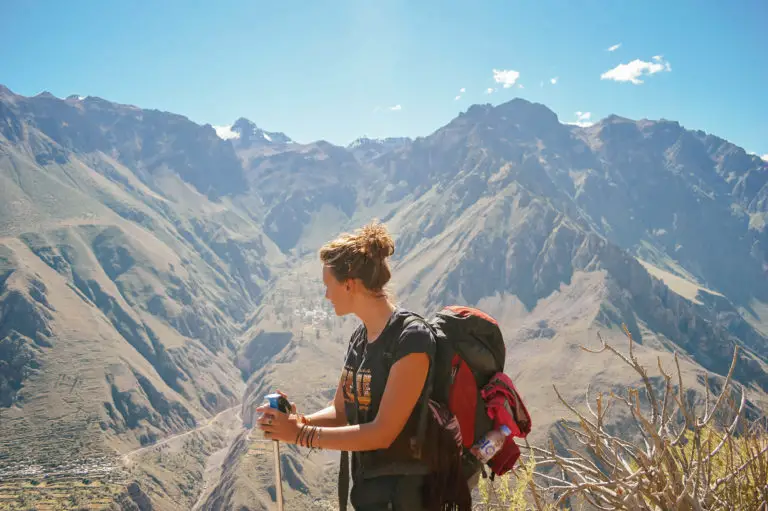 girl with backpack with mountain canyon in background
