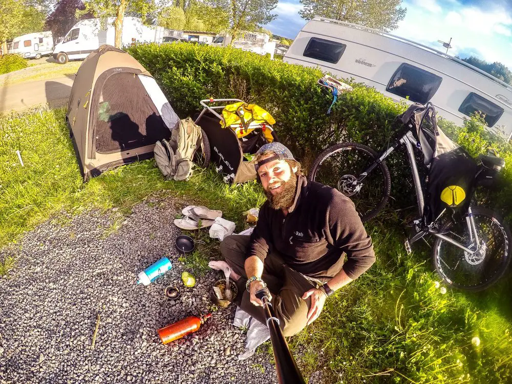 go pro selfie with tent and bike on campsite