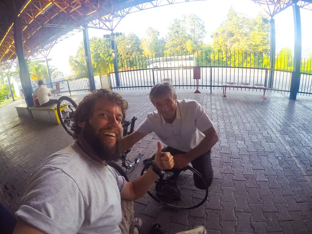 selfie with men fixing a bike