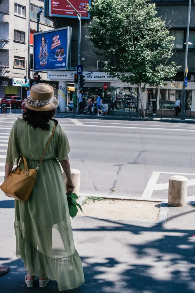 lady in dress crossing the road