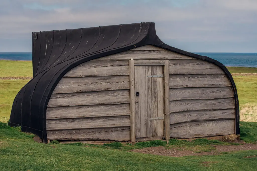 wooden boat shed on grass