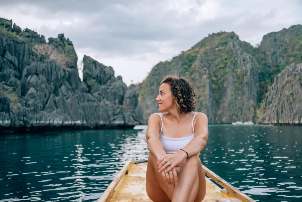 girl in bikini sat on boat in el nido