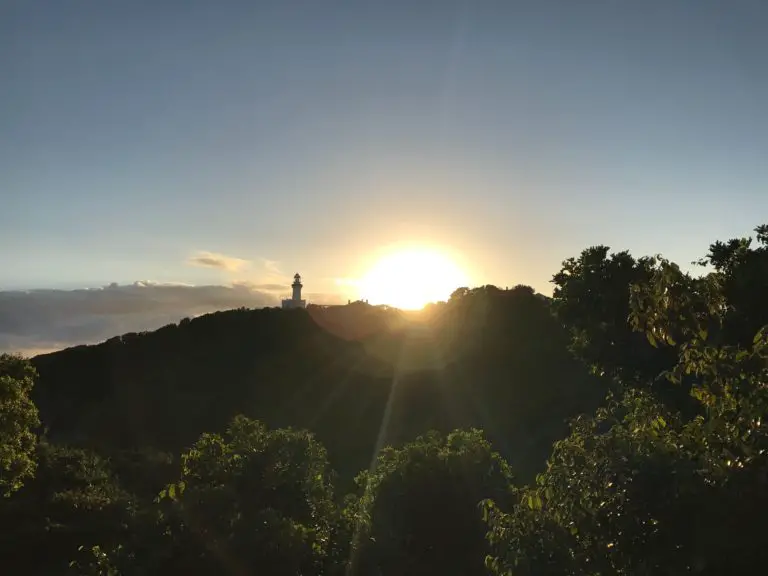 byron bay at sunset with lighthouse in distance