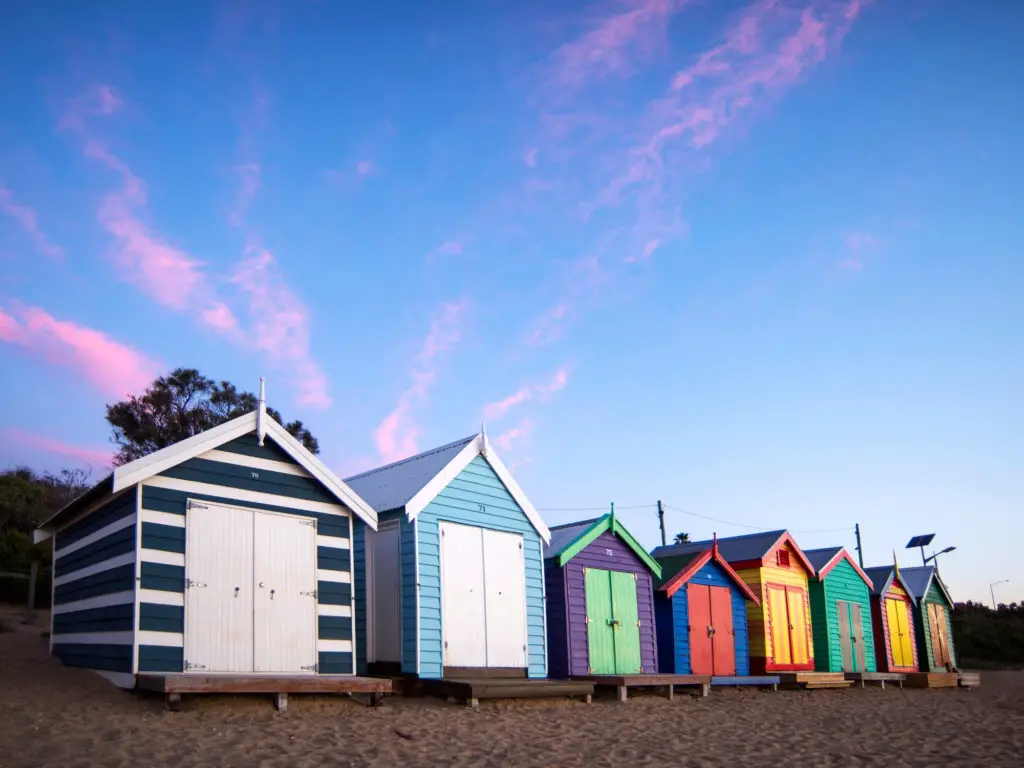 brighton beach boxes in melbourne with pink clouds