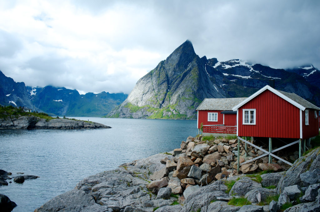 nordic house on a lake with rugged mountains