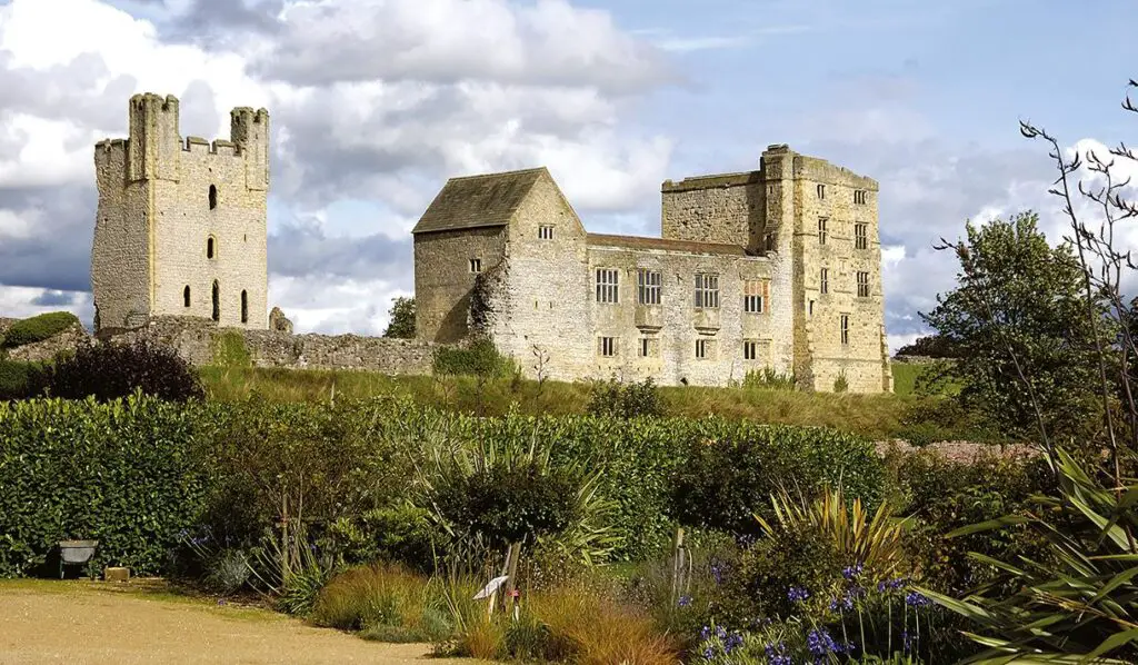 Helmsley Castle with flower bed in foreground