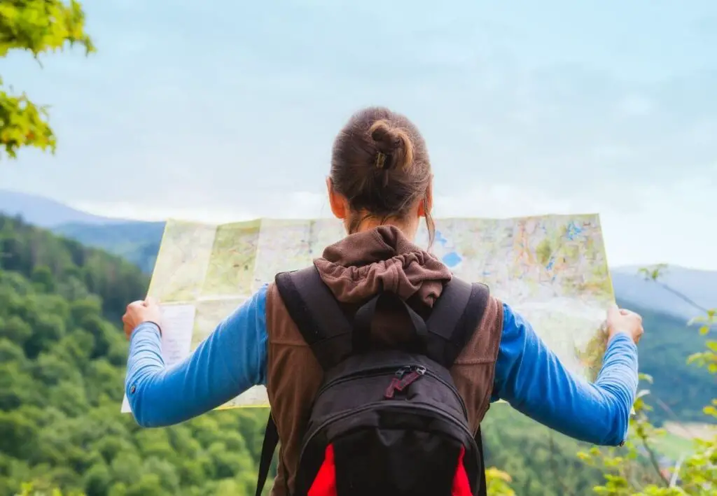 girl holding map whilst hiking alone