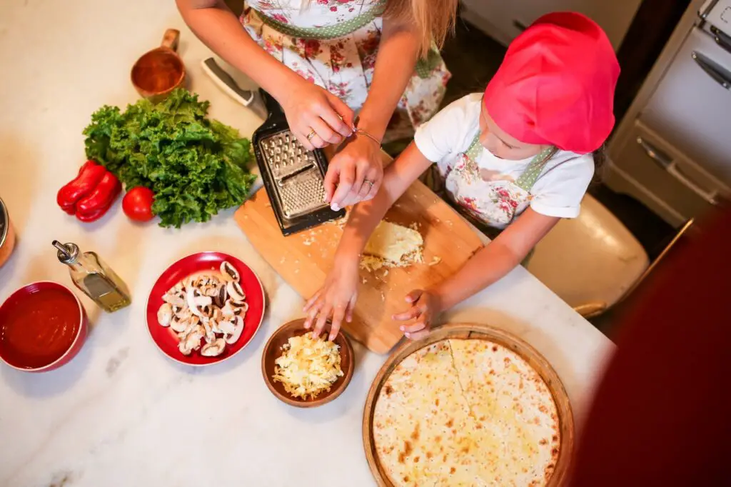 ariel shot of girl and lady cooking in kitchen