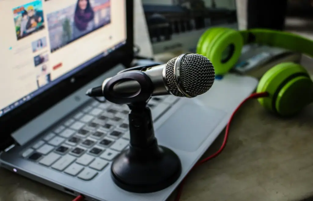 microphone on a laptop with green headphones