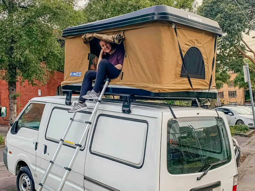 pop up roof top tent on top of small white van