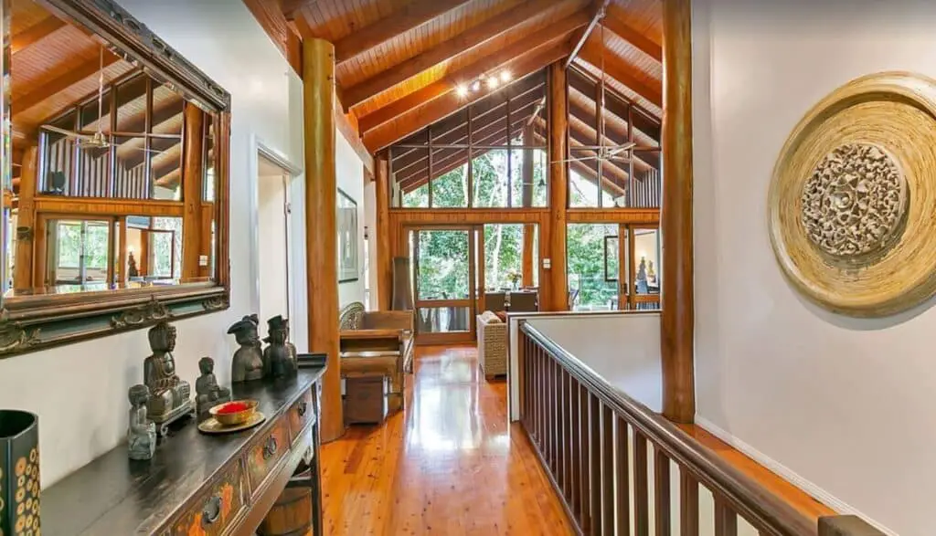 interior of a Balinese inspired treehouse in Queensland with a high wooden ceiling and white walls 