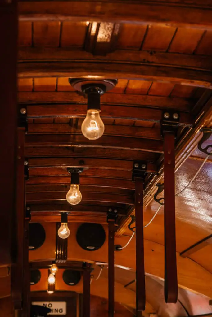 hanging lightbulbs on a wooden ceiling in a vintage tram carriage