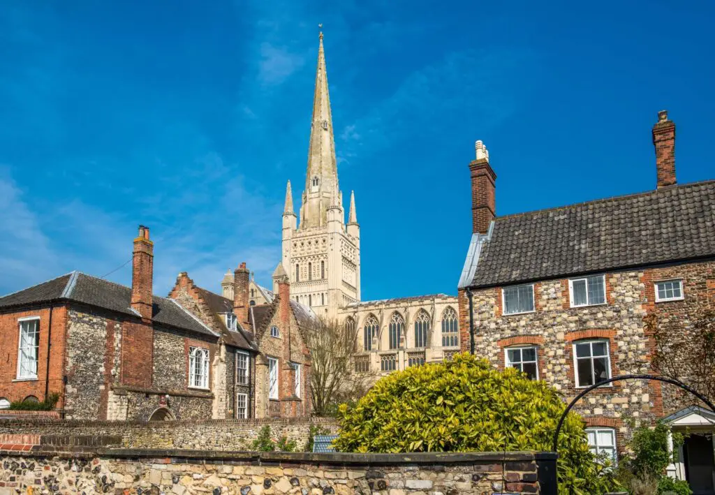 spire of Norwich cathedral behind houses