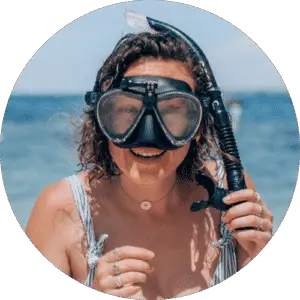 smiling girl in swimsuit with snorkel on