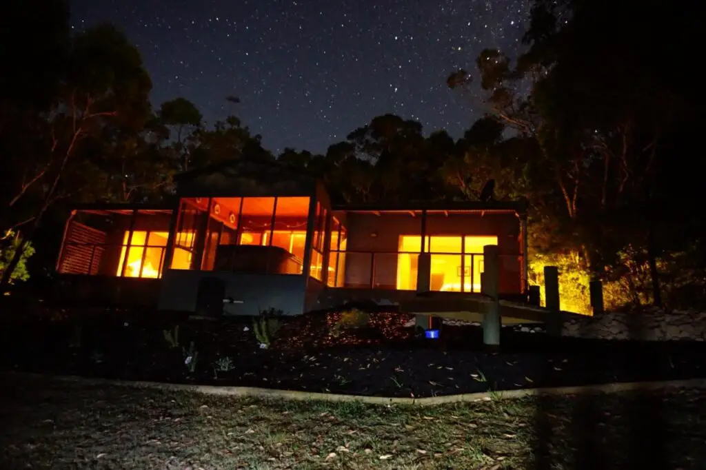 large wooden house lit up at night