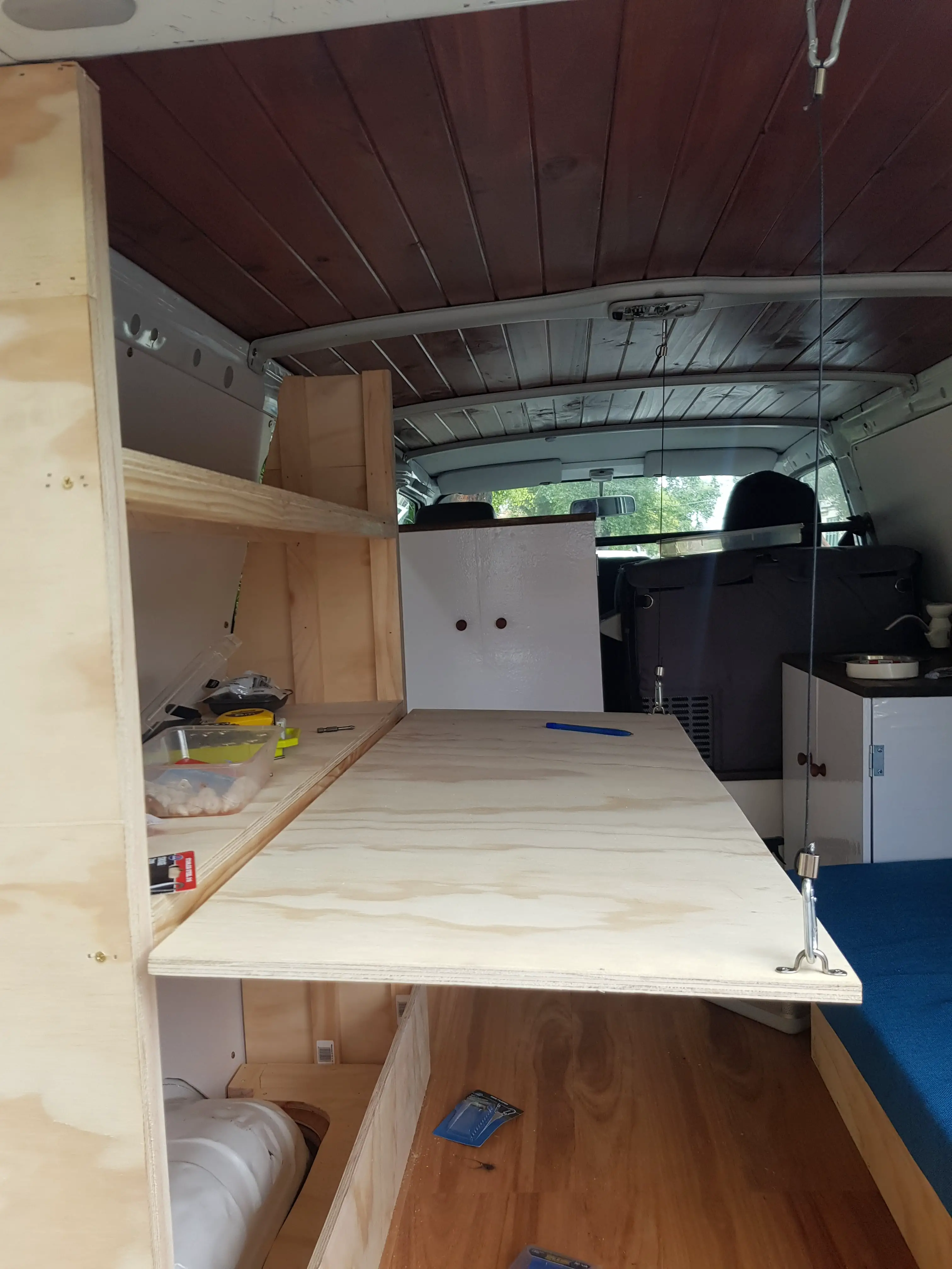 fold out table from a shelf in a camper van