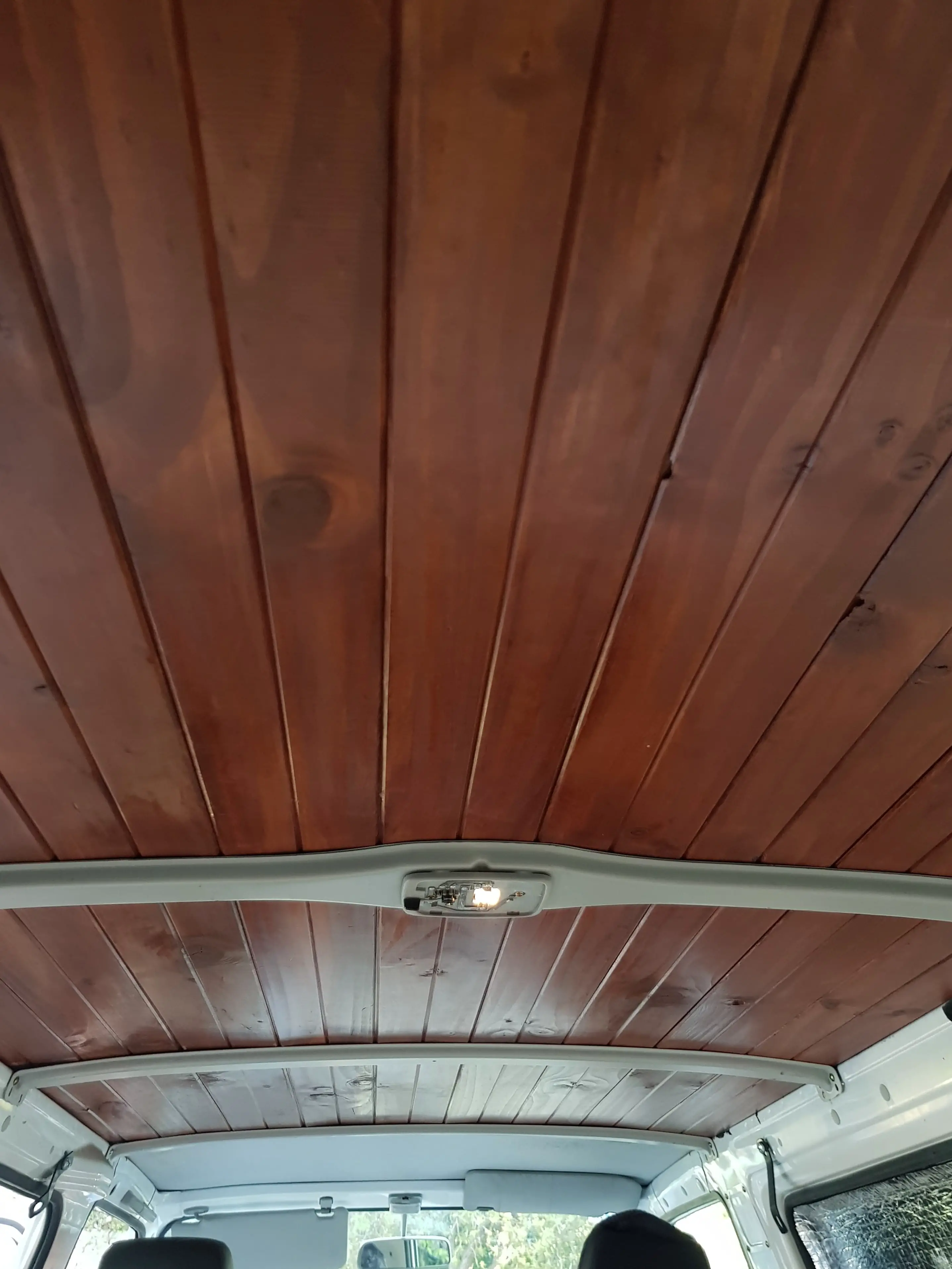 stained wooden ceiling in a camper van