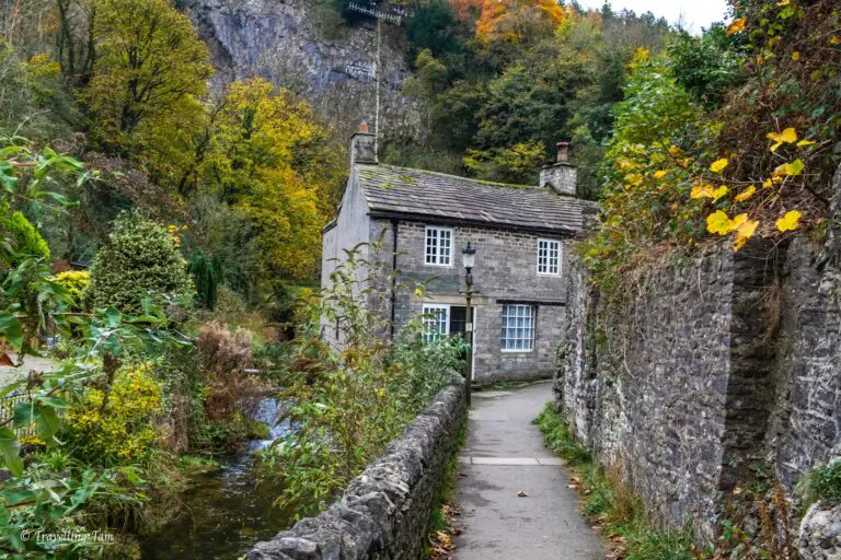 A stone house beside the river and in front of Peak Cavern