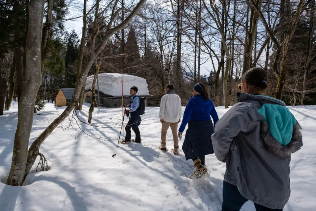 a group of people snowshoeing in Iiyama